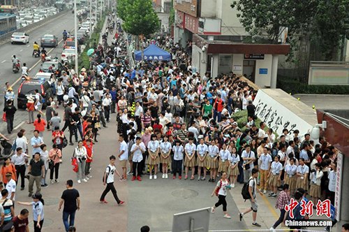 资料图：6月7日，2016年中国高考正式拉开大幕。图为河南省实验中学考点外，站满了前来送考生考试的家长们。 周小云 摄